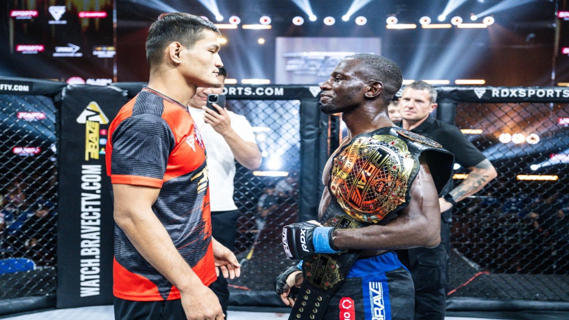 Nicholas Hwende celebrates after becoming the Undisputed BRAVE CF Featherweight World Champion, with multiple championship paths ahead following his historic victory.