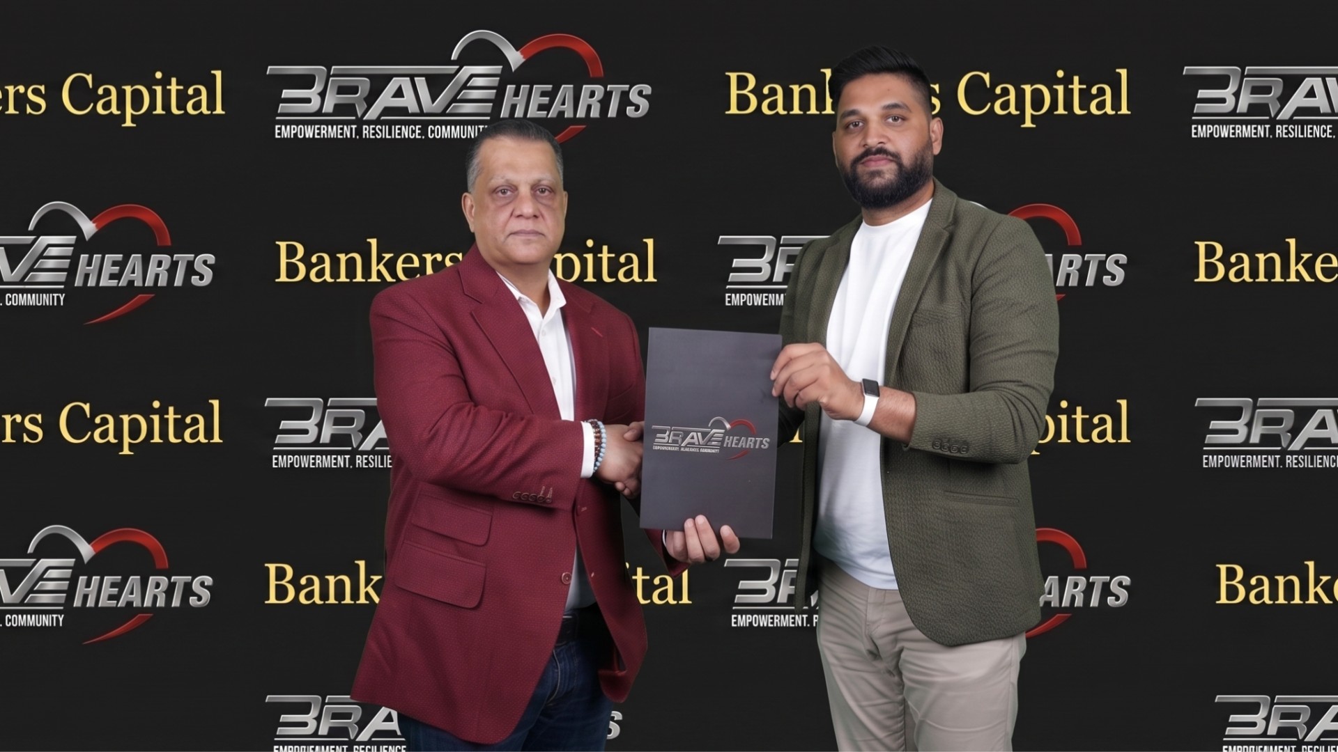 BRAVE Hearts Director Jabran Zakariya and Bankers Capital Co-founder Faisal Rehman sign a partnership agreement to advance community prosperity.